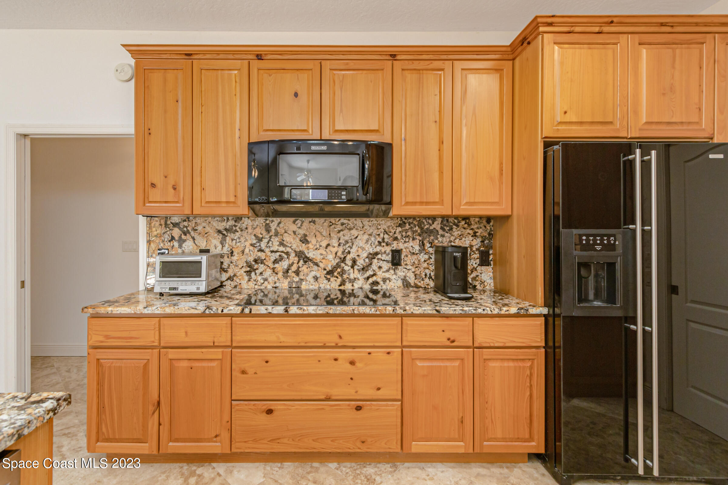 271 Deer Run Road Palm Bay, FL 32909 - Photo 12 of 61 a kitchen with stainless steel appliances granite countertop a refrigerator a stove a sink and cabinets