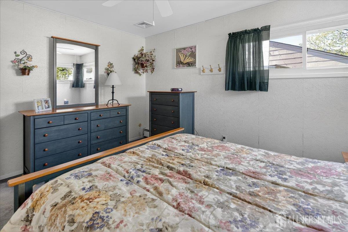 13 Comstock Road Edison, NJ 08817 - Photo 12 of 22 a bedroom with a bed and a dresser in it