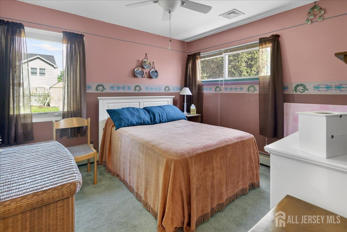 13 Comstock Road Edison, NJ 08817 - Photo 13 of 22 a bedroom with a bed and a table