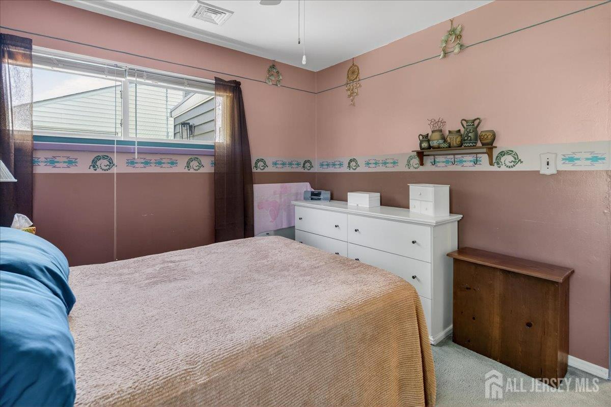 13 Comstock Road Edison, NJ 08817 - Photo 14 of 22 a bedroom with a bed and a window