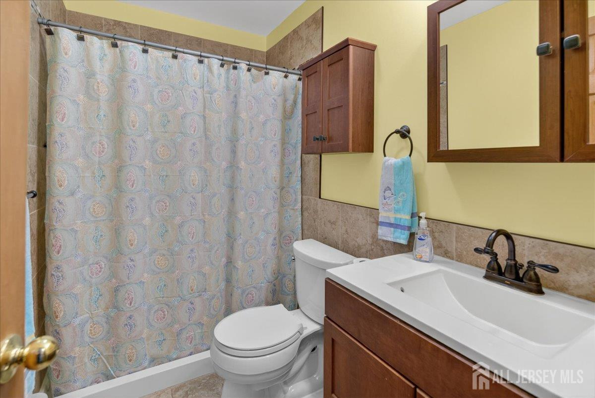 13 Comstock Road Edison, NJ 08817 - Photo 17 of 22 a bathroom with a sink and a mirror