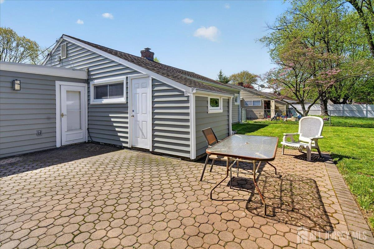 13 Comstock Road Edison, NJ 08817 - Photo 19 of 22 a backyard of a house with barbeque oven table and chairs