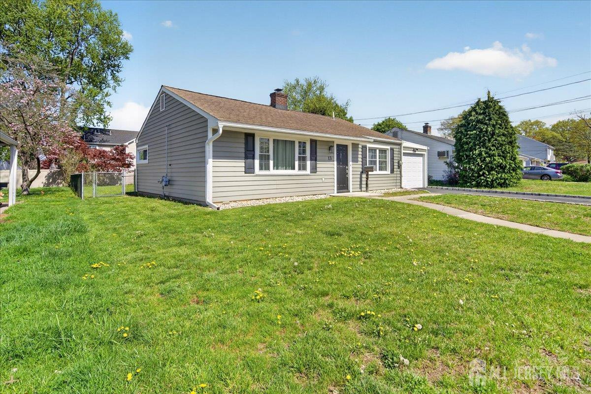 13 Comstock Road Edison, NJ 08817 - Photo 2 of 22 a front view of a house with a garden