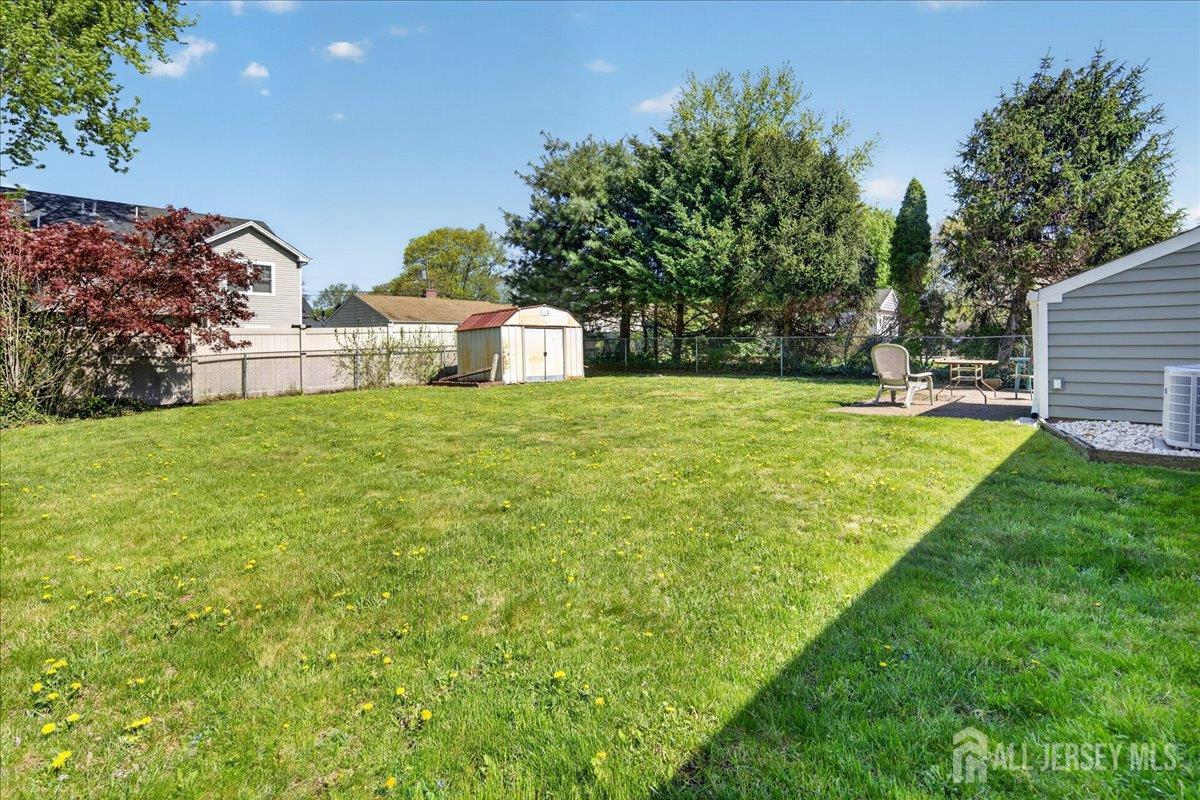 13 Comstock Road Edison, NJ 08817 - Photo 22 of 22 a view of a house with a yard and sitting area