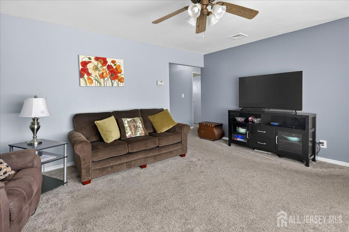 13 Comstock Road Edison, NJ 08817 - Photo 4 of 22 a living room with furniture and a flat screen tv