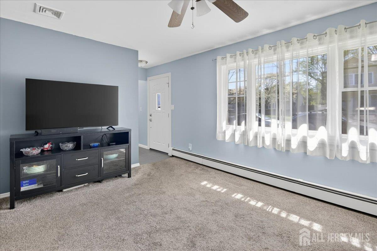 13 Comstock Road Edison, NJ 08817 - Photo 5 of 22 a living room with furniture and a flat screen tv