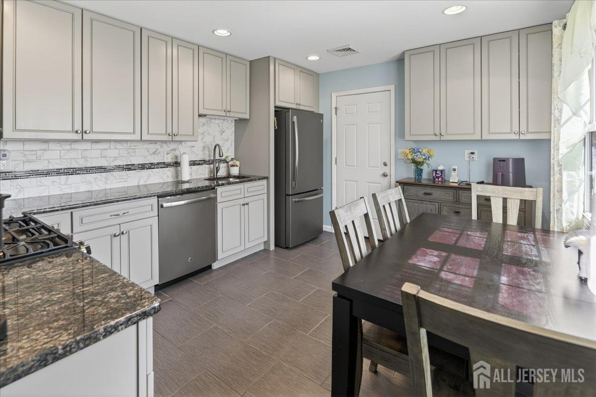 13 Comstock Road Edison, NJ 08817 - Photo 7 of 22 a kitchen with stainless steel appliances granite countertop a stove refrigerator sink and cabinets