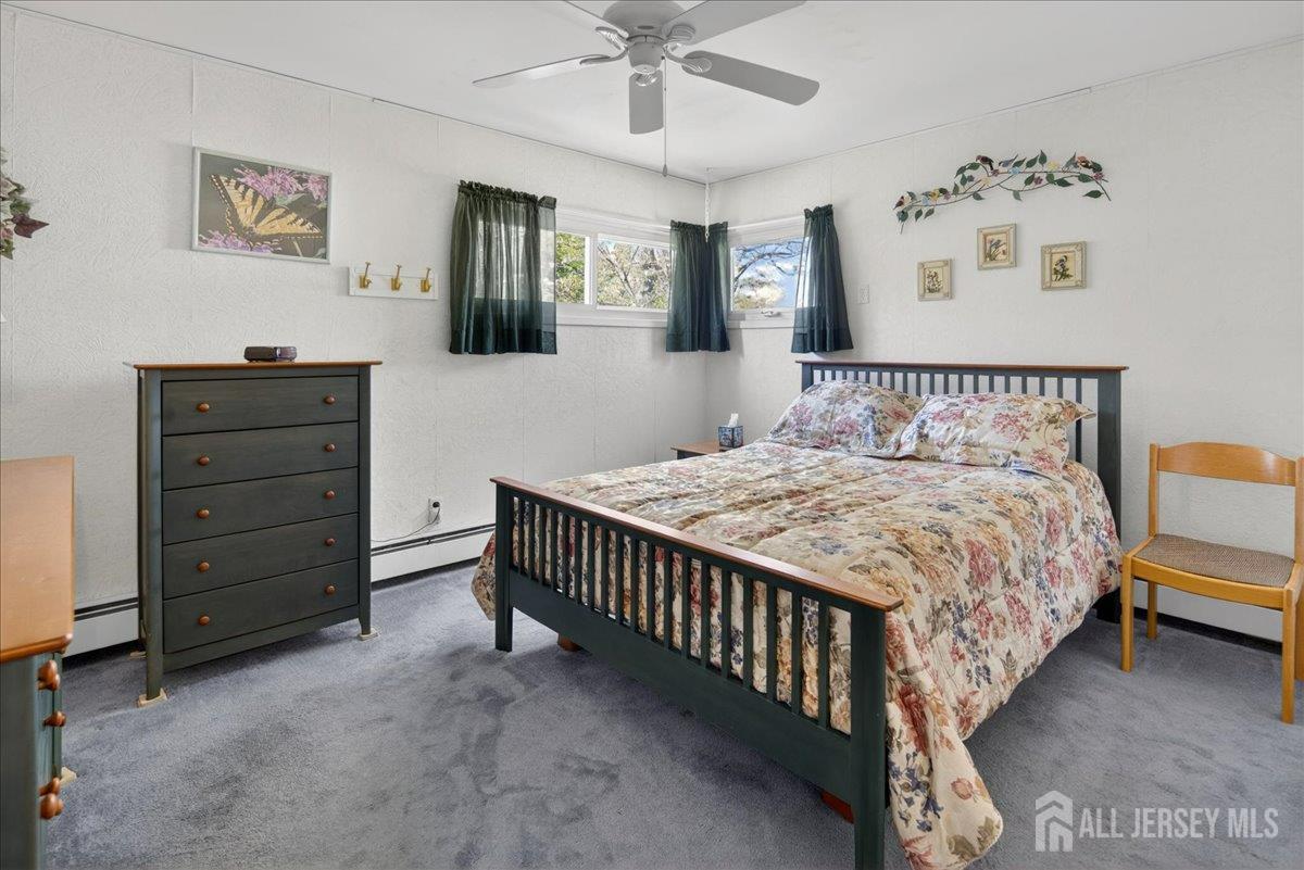 13 Comstock Road Edison, NJ 08817 - Photo 10 of 22 a bedroom with a bed and a chandelier