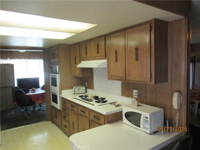 a kitchen with a stove a refrigerator and a sink