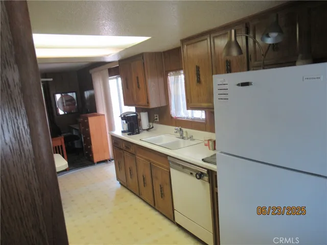 a kitchen with a sink and a refrigerator