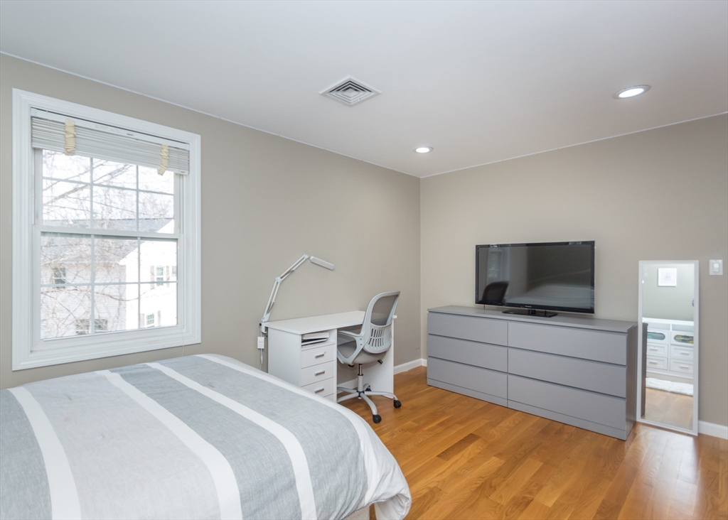 985 Trapelo Road, Unit 23 Waltham, MA 02452 - Photo 16 of 27 a bedroom with a bed and a flat screen tv