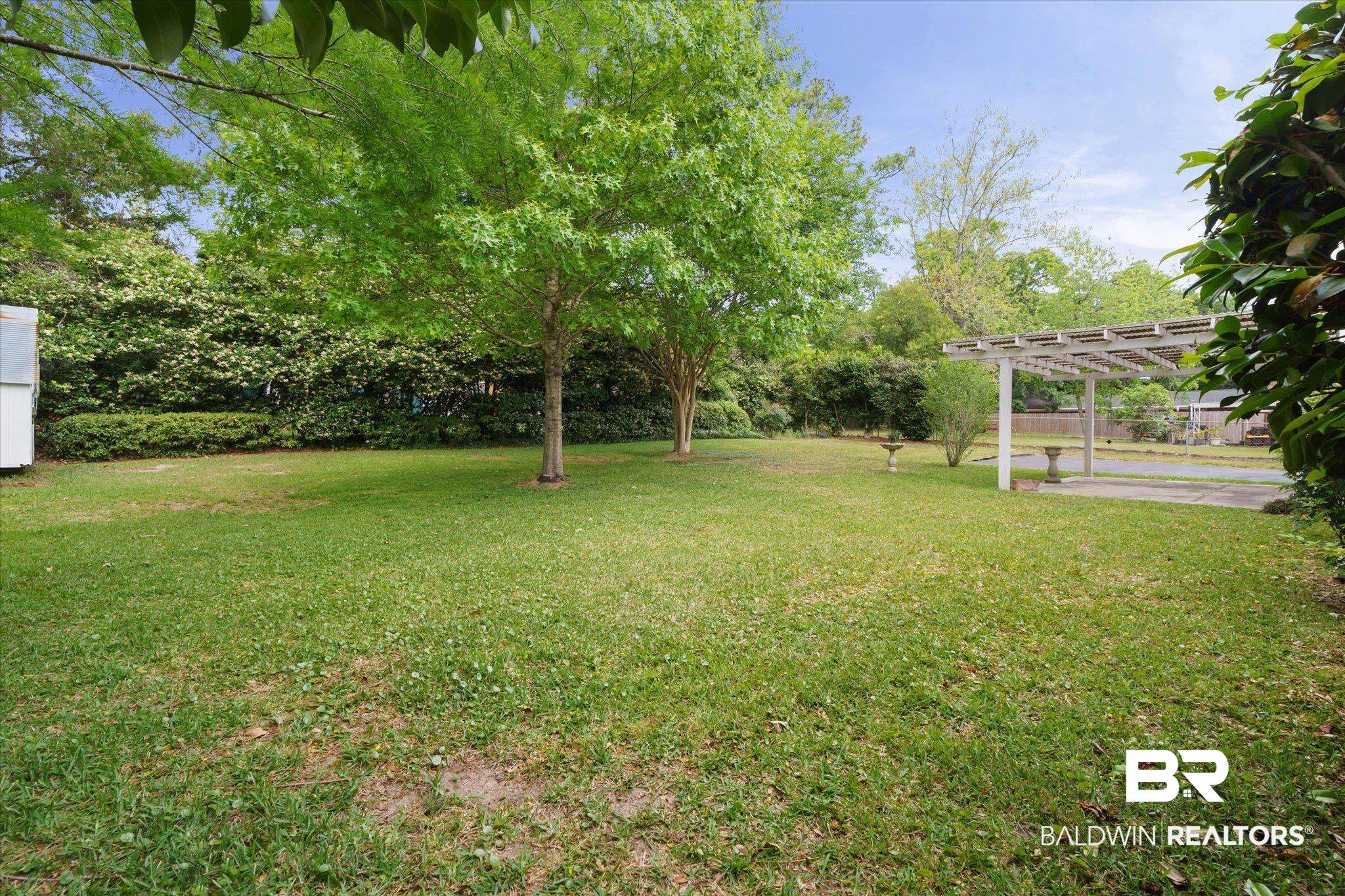 1182 Ginger Drive Mobile, AL 36693 - Photo 30 of 37 Expansive green lawn with mature trees and a white pergola structure