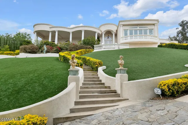 a kitchen with stainless steel appliances granite countertop a stove top oven a sink dishwasher and cabinets with wooden floor