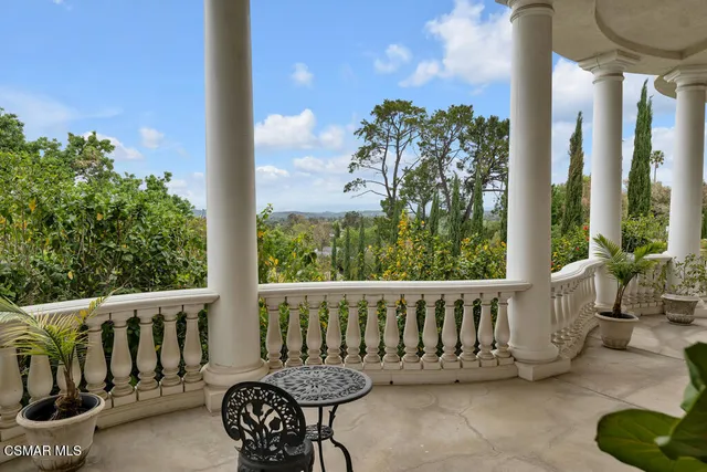 a living room with furniture flat screen tv and a large window