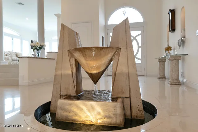 a bedroom with a large bed and a flat tv screen