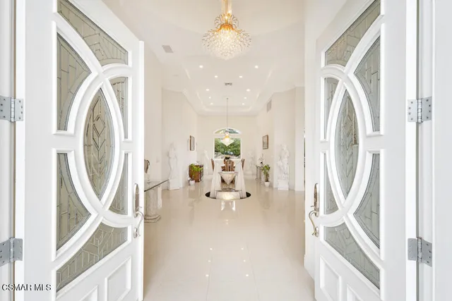 a dining room with furniture and a chandelier