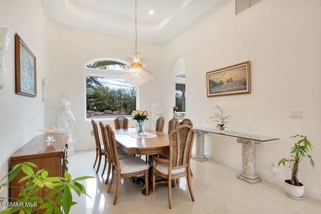 a bathroom with a granite countertop sink a large mirror and a bathtub