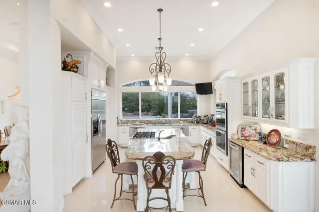 a large white kitchen with a large window
