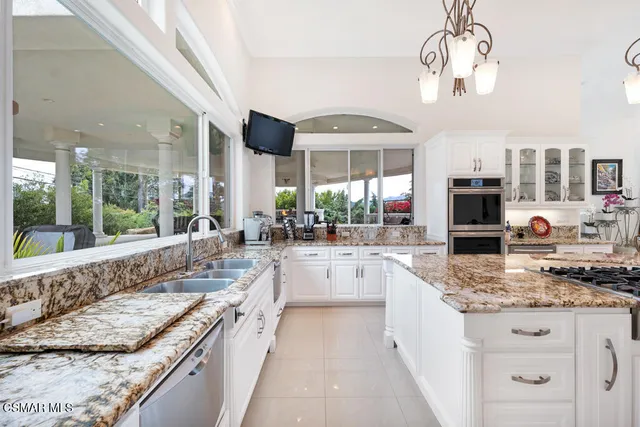 a view of a hallway with wooden floor and a bathroom