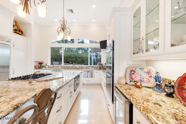 a bathroom with a granite countertop sink mirror and vanity