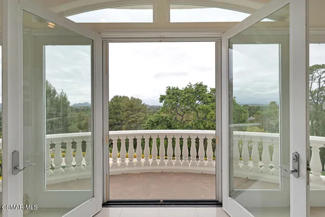 a work room with furniture and large windows