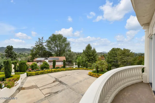a view of a patio with table and chairs potted plants with large tree