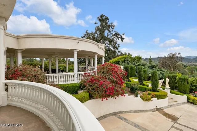 a view of a house with swimming pool and sitting area