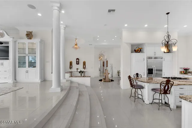 a view of a house with a chairs and potted plants