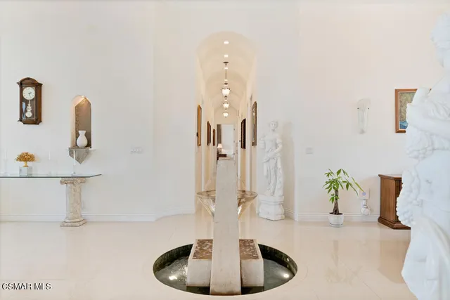 an aerial view of a house with a yard and trees