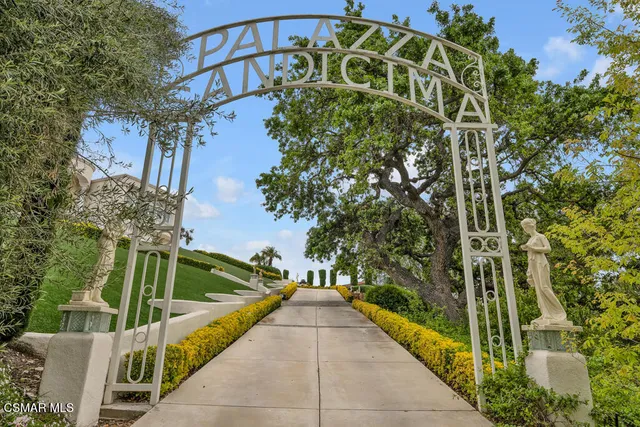 a front view of a house with a garden and plants