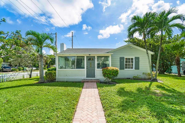 a view of a house with a yard and tree s
