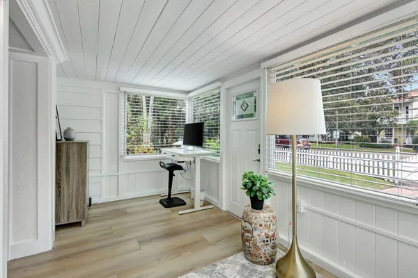 a view of a livingroom with wooden floor and furniture