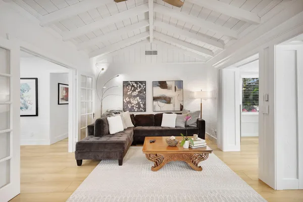 a living room with furniture and wooden floor
