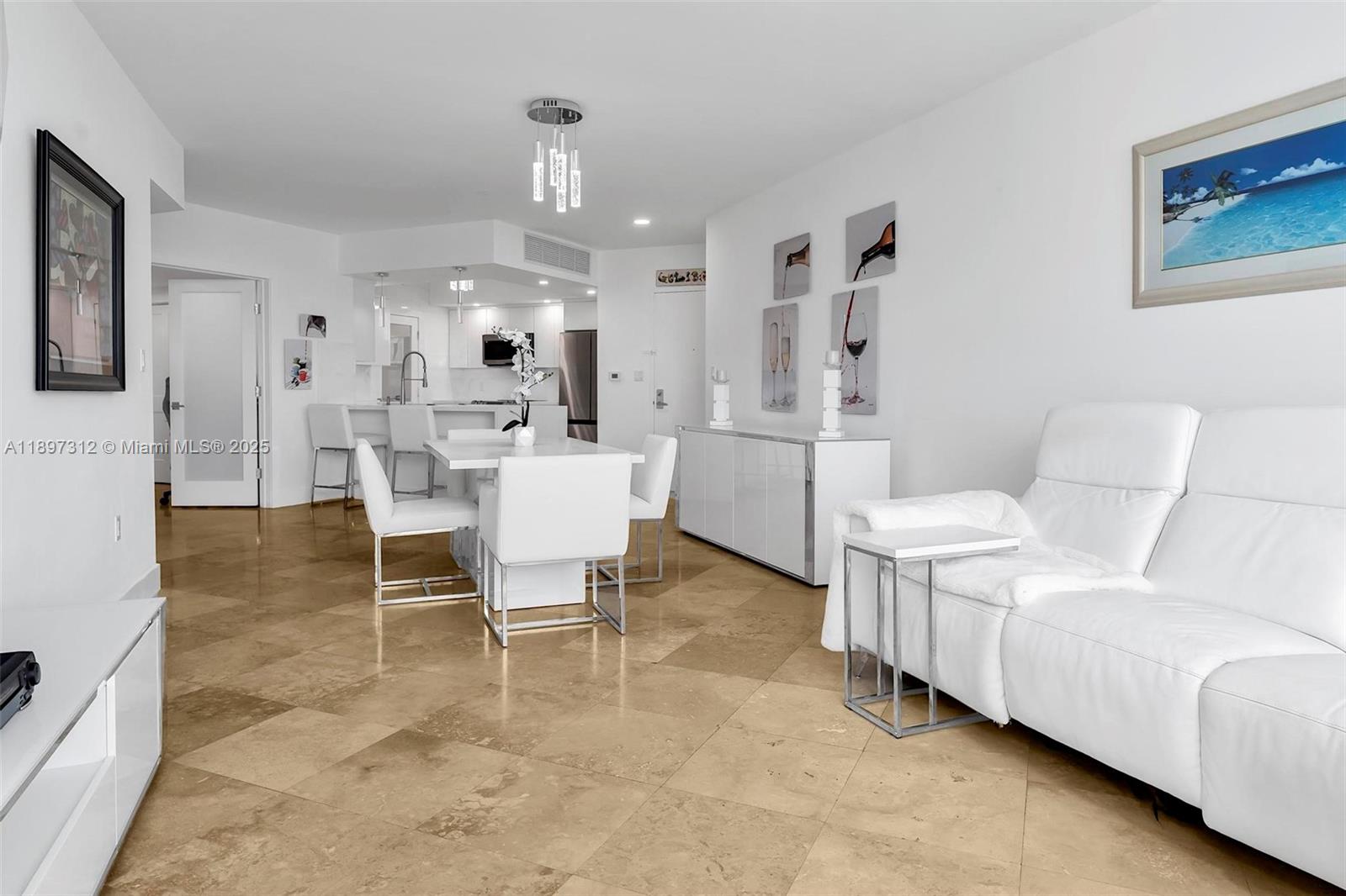 9066 Southwest 73rd Court, Unit 2110 Miami, FL 33156 - Photo 20 of 45 a living room with furniture and a chandelier