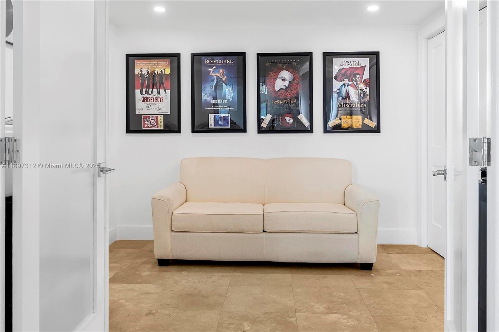 9066 Southwest 73rd Court, Unit 2110 Miami, FL 33156 - Photo 22 of 45 a living room with furniture and a painting on the wall