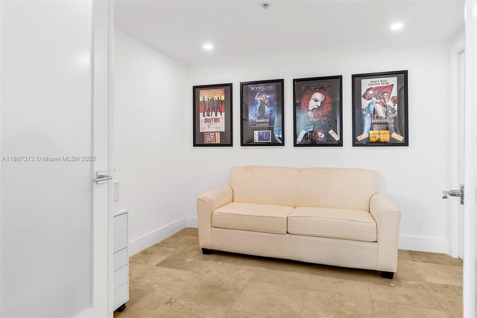 9066 Southwest 73rd Court, Unit 2110 Miami, FL 33156 - Photo 23 of 45 a living room with furniture and wall paintings