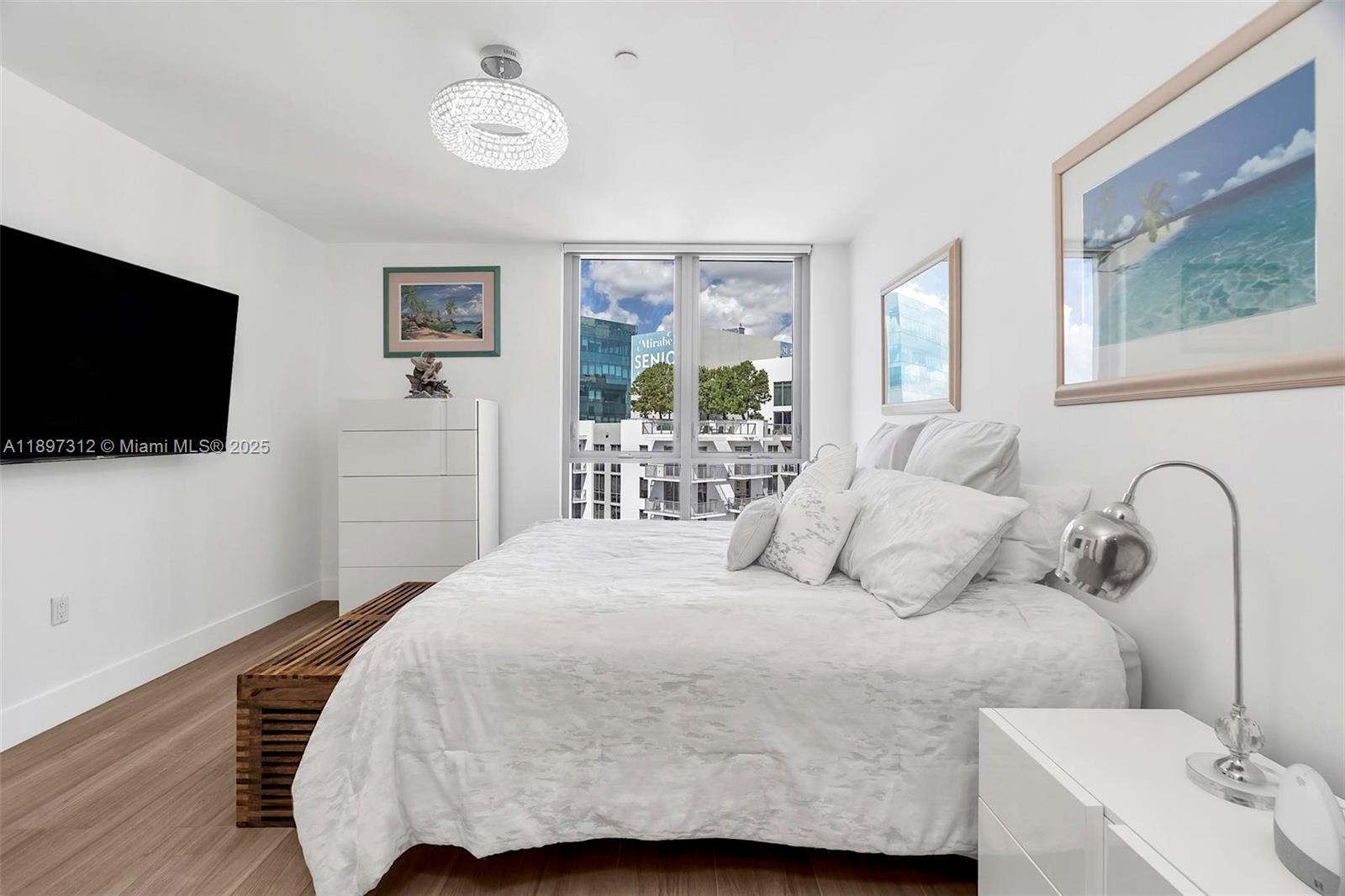 9066 Southwest 73rd Court, Unit 2110 Miami, FL 33156 - Photo 31 of 45 a bedroom with a bed and a flat screen tv