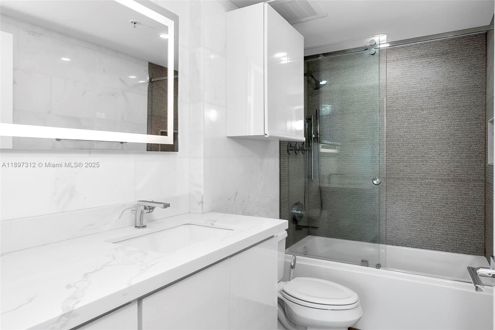 9066 Southwest 73rd Court, Unit 2110 Miami, FL 33156 - Photo 34 of 45 a bathroom with a sink a toilet and shower