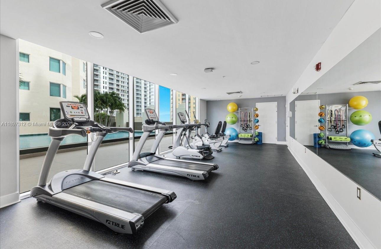 9066 Southwest 73rd Court, Unit 2110 Miami, FL 33156 - Photo 39 of 45 a view of a room with gym equipment