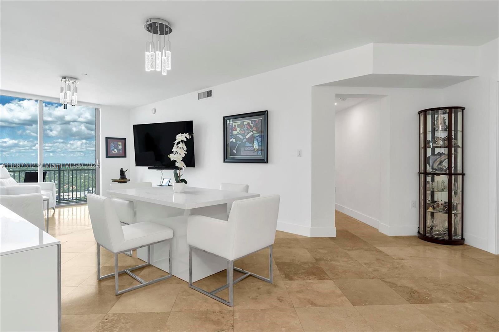 9066 Southwest 73rd Court, Unit 2110 Miami, FL 33156 - Photo 5 of 45 a view of a livingroom with furniture and a flat screen tv