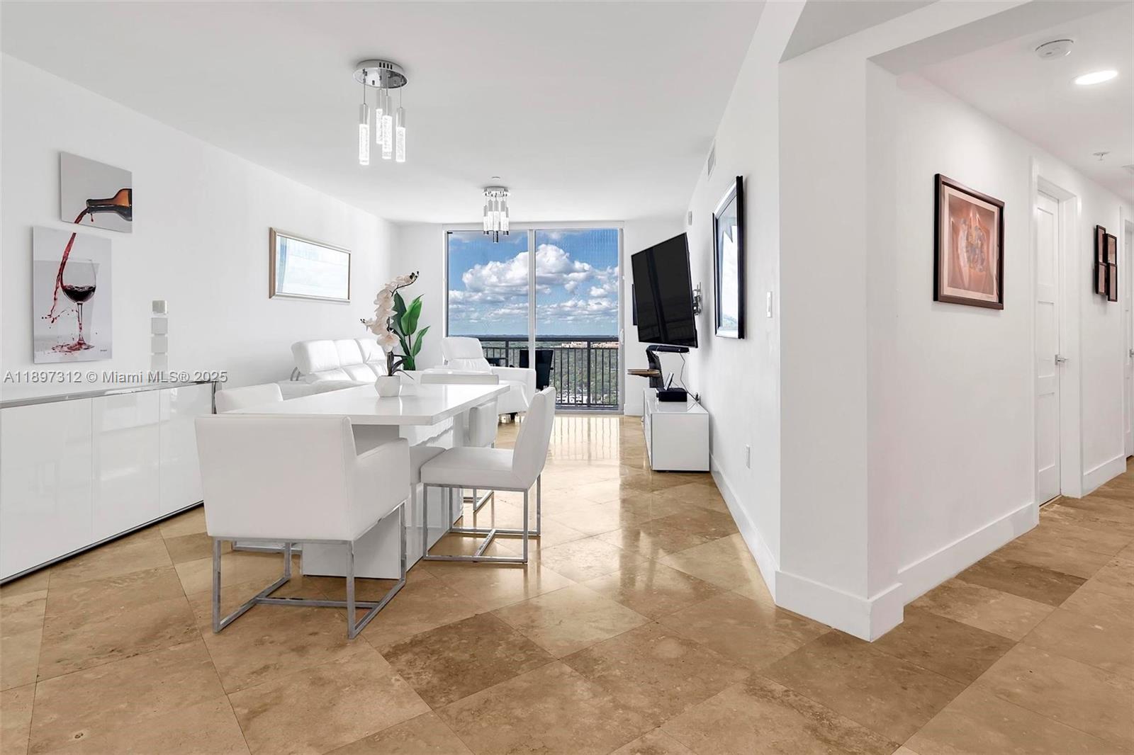 9066 Southwest 73rd Court, Unit 2110 Miami, FL 33156 - Photo 6 of 45 a view of a livingroom with furniture and a flat screen tv