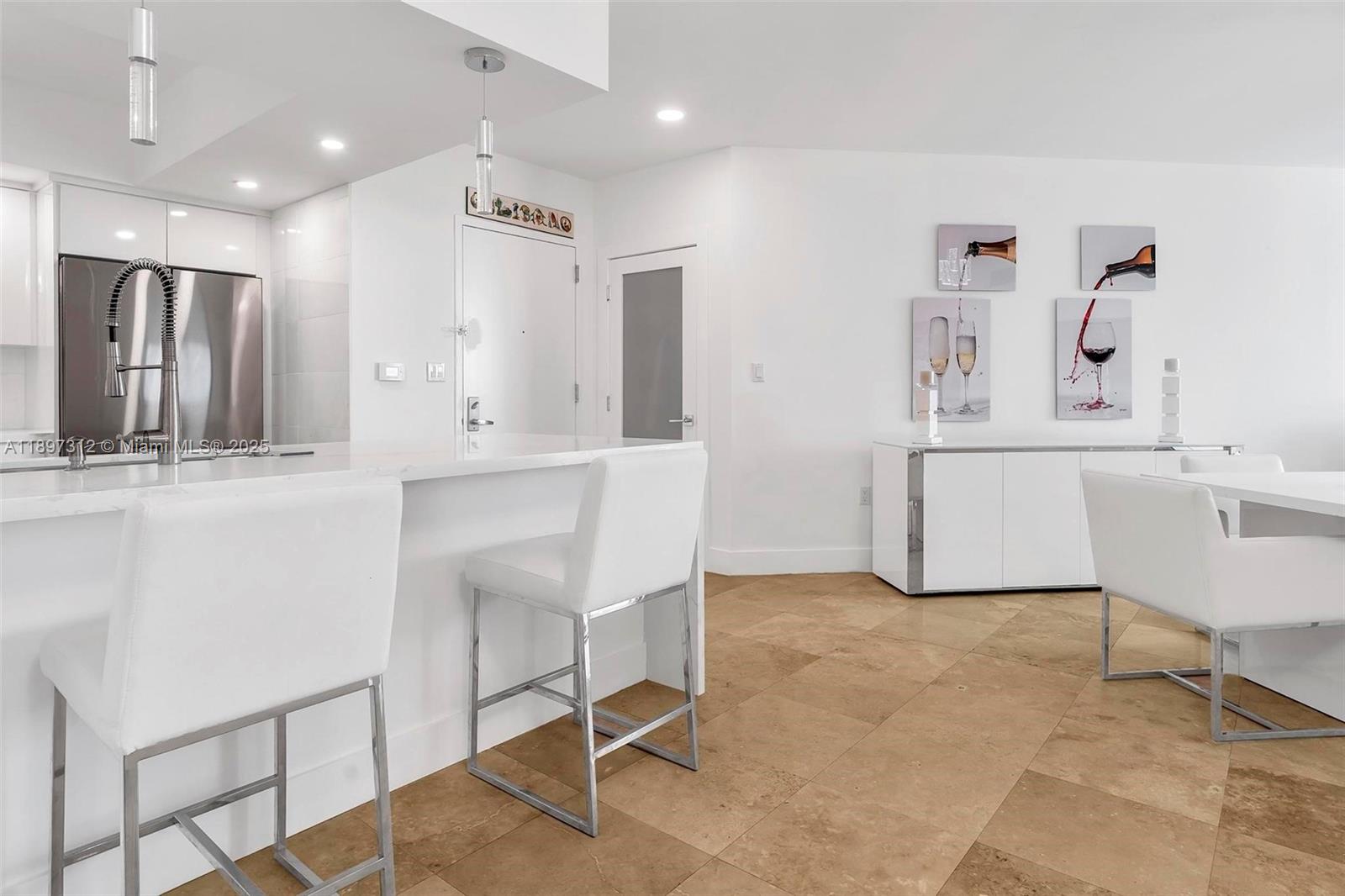 9066 Southwest 73rd Court, Unit 2110 Miami, FL 33156 - Photo 7 of 45 a kitchen with kitchen island white cabinets and stainless steel appliances