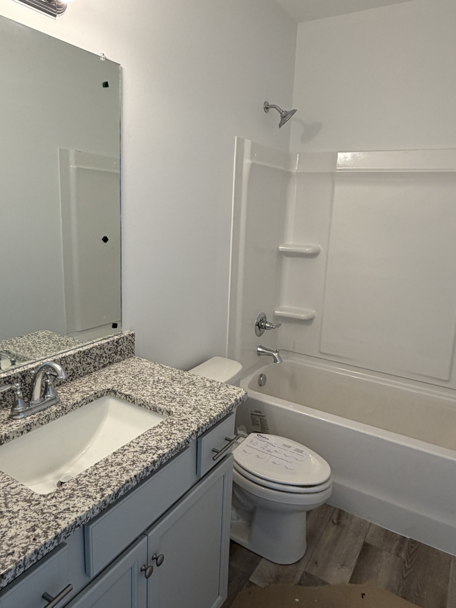 1209 Euclid Murfreesboro, TN 37127 - Photo 12 of 14 a bathroom with a granite countertop sink a toilet and shower