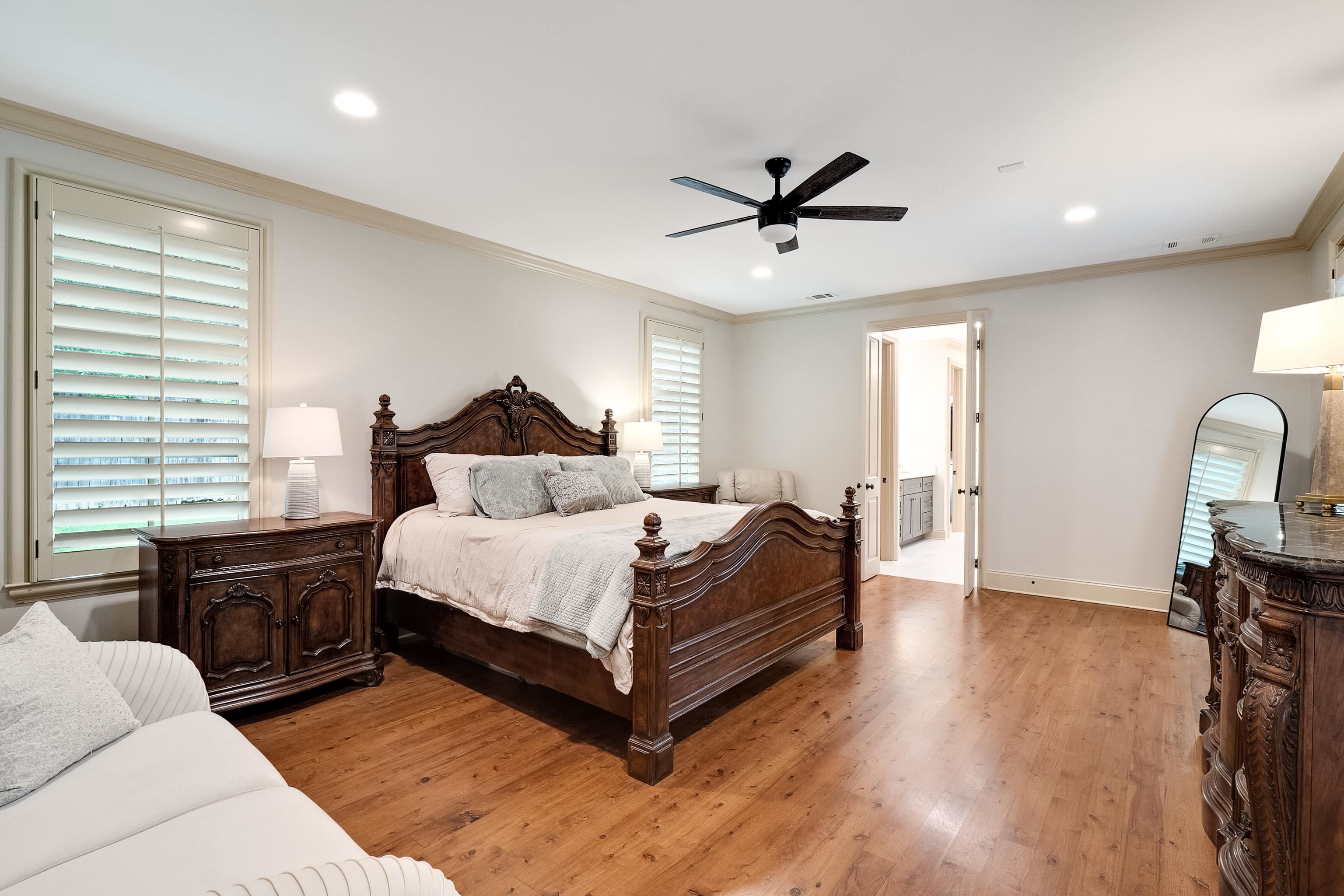 5720 Shady Grove Road Memphis, TN 38120 - Photo 17 of 40 a bedroom with a bed wooden floor and furniture