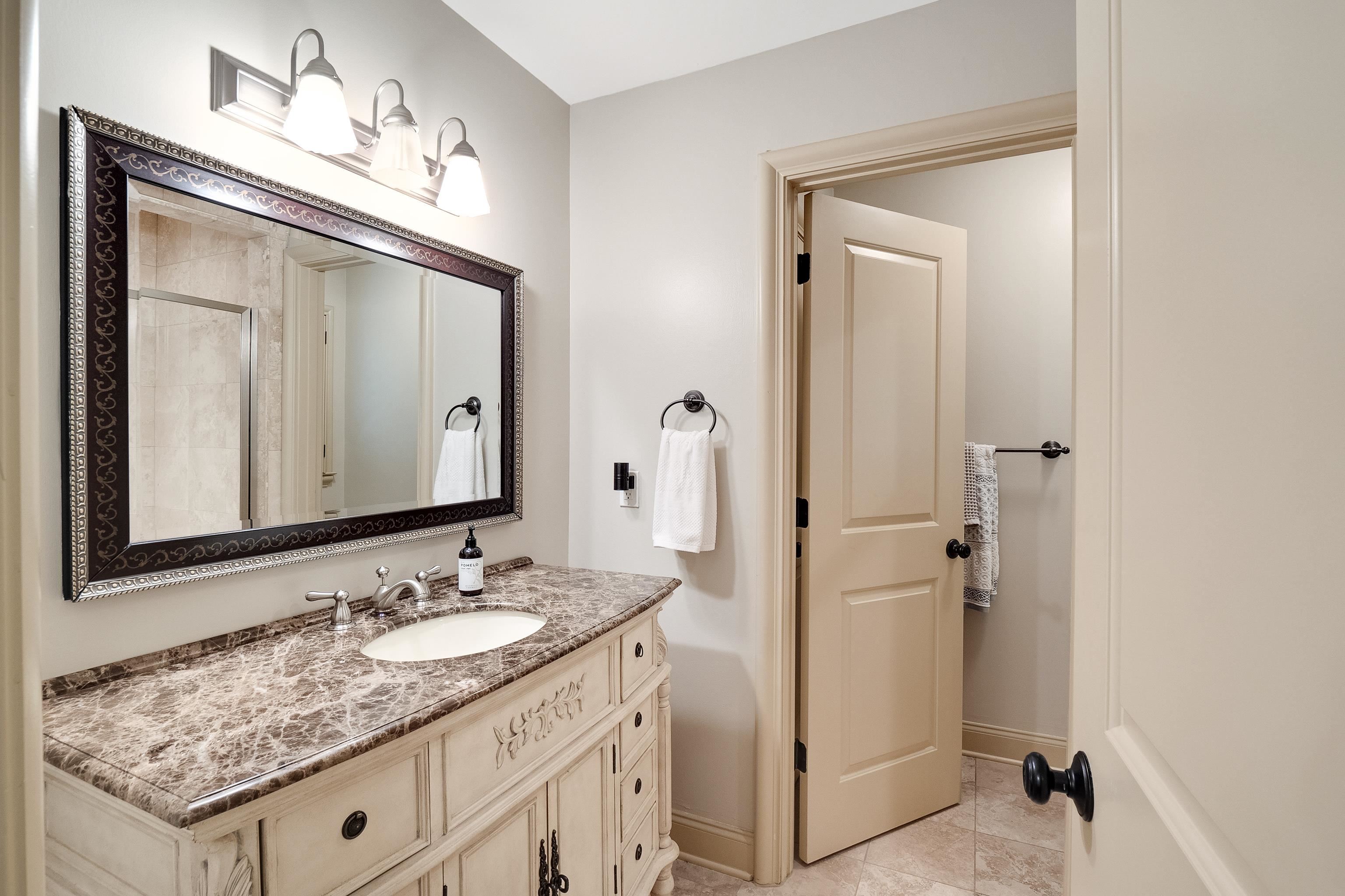 5720 Shady Grove Road Memphis, TN 38120 - Photo 23 of 40 a bathroom with a granite countertop sink vanity and mirror