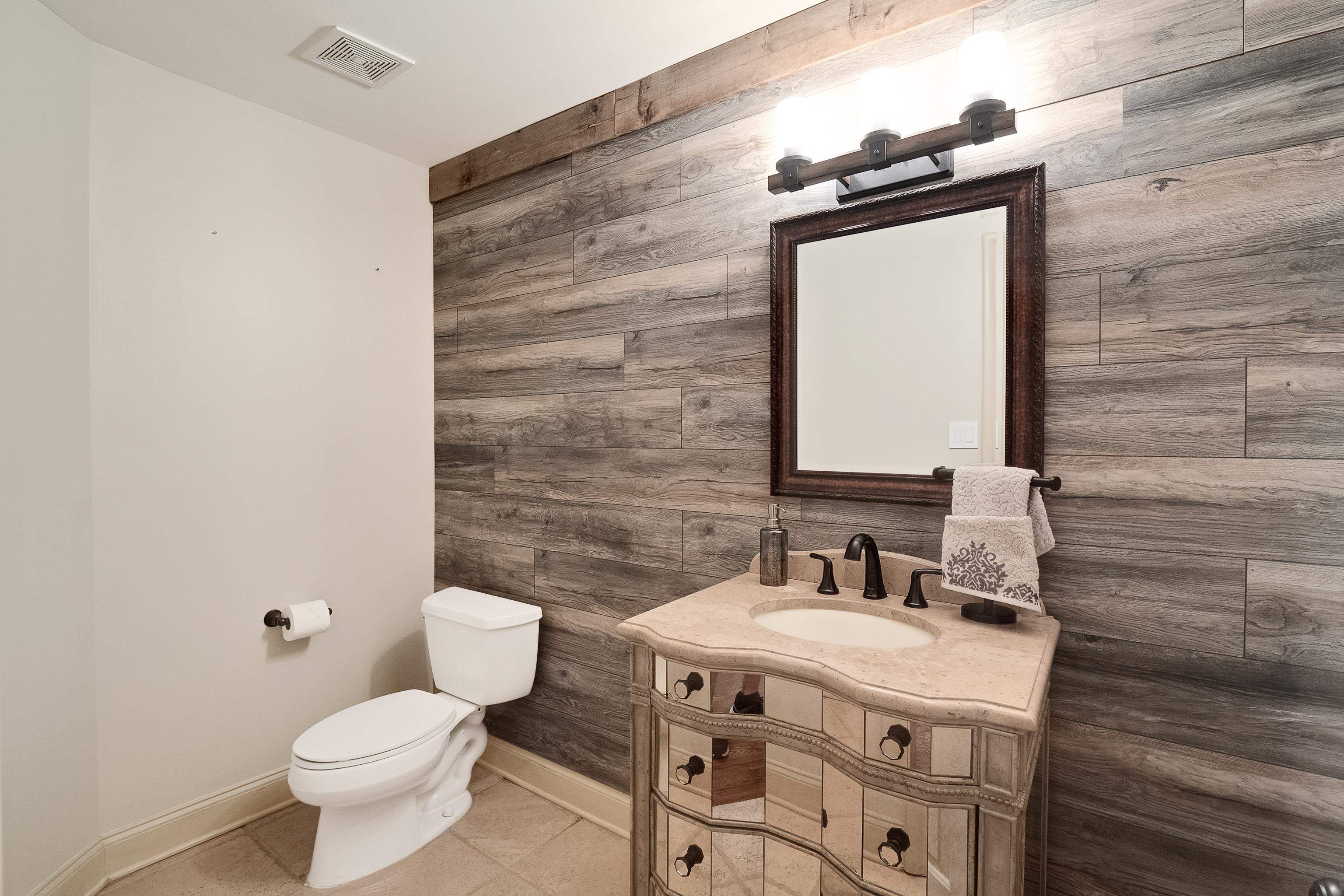 5720 Shady Grove Road Memphis, TN 38120 - Photo 24 of 40 a bathroom with a granite countertop toilet a sink and a mirror