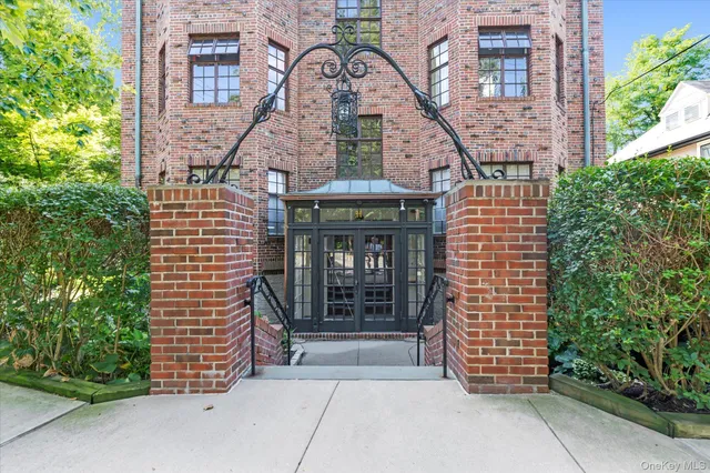 a front view of a building with garden