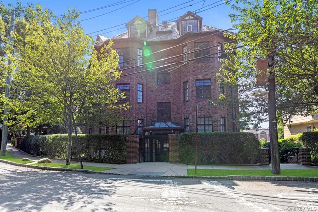 a view of a brick building next to a yard