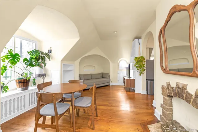a view of a dining room with furniture and a potted plant