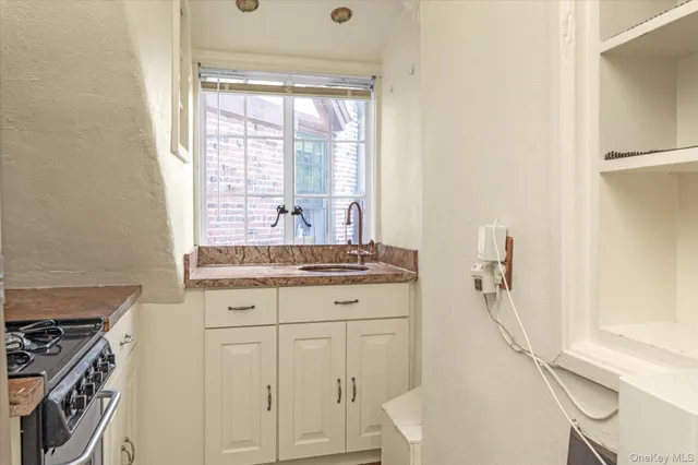 a bathroom with a granite countertop sink a toilet and a mirror